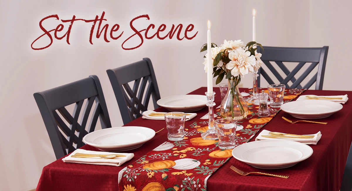 A festive thanksgiving table with 4 place settings.