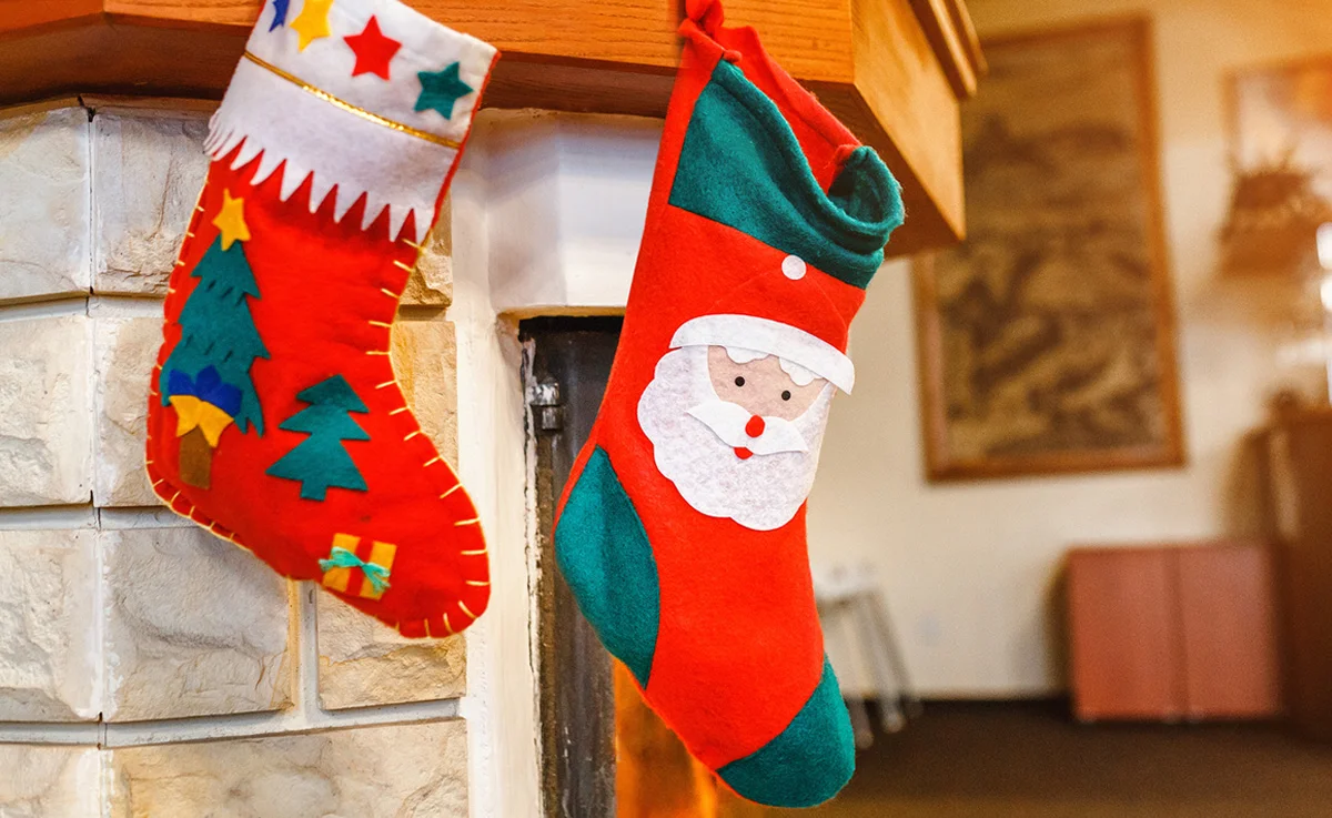 Christmas stocking socks hang on fireplace background.