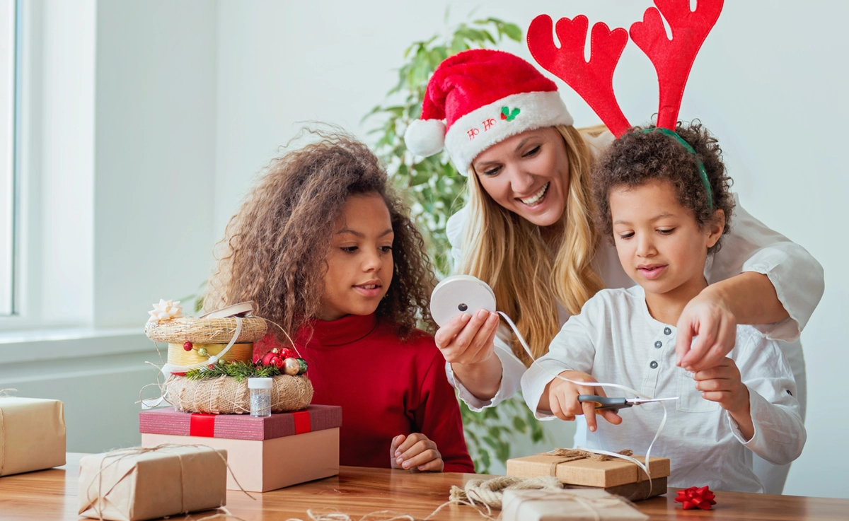 A family wrapping Christmas presents