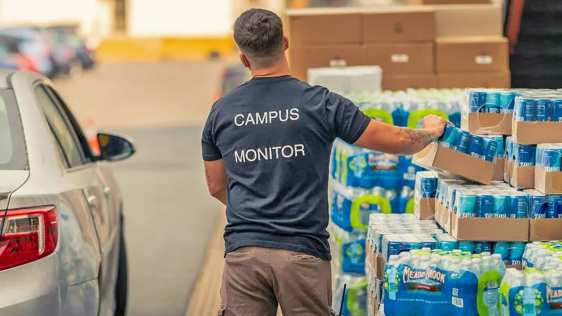 Volunteers with cases of water