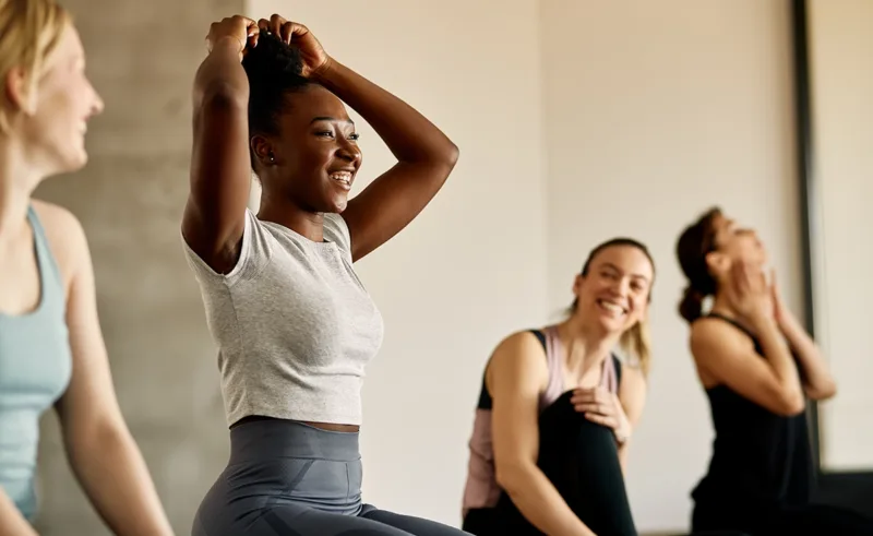 A woman having fun working out with her friends.