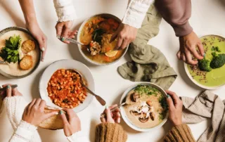 A variety of winter soups laid out on a table.