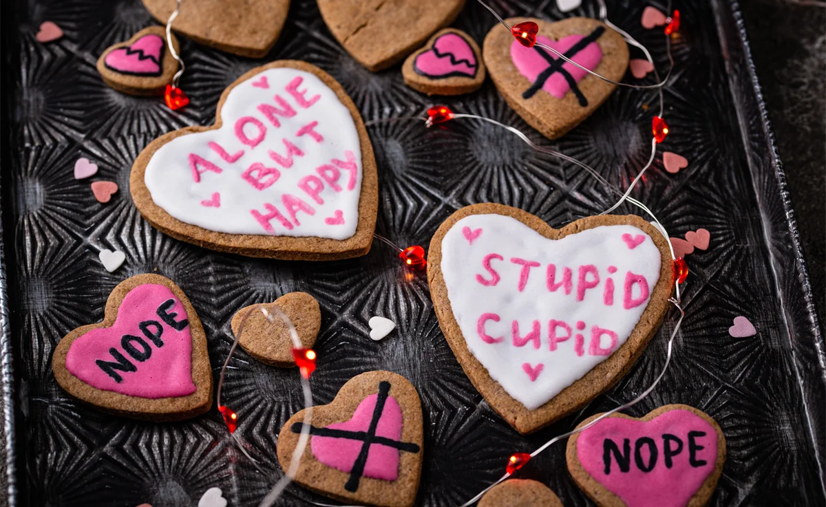 Anti-Valentine day cookies with frosting that reads Alone But Happy