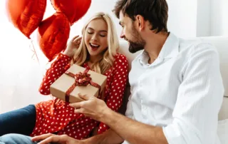 A couple exchanging Valentine’s Day gifts.