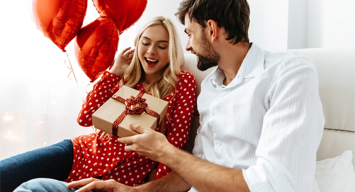 A couple exchanging Valentine’s Day gifts.