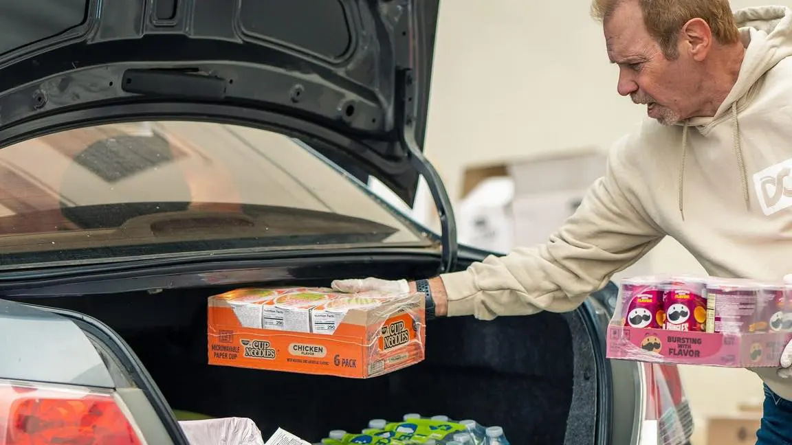 Volunteers load car with supplies