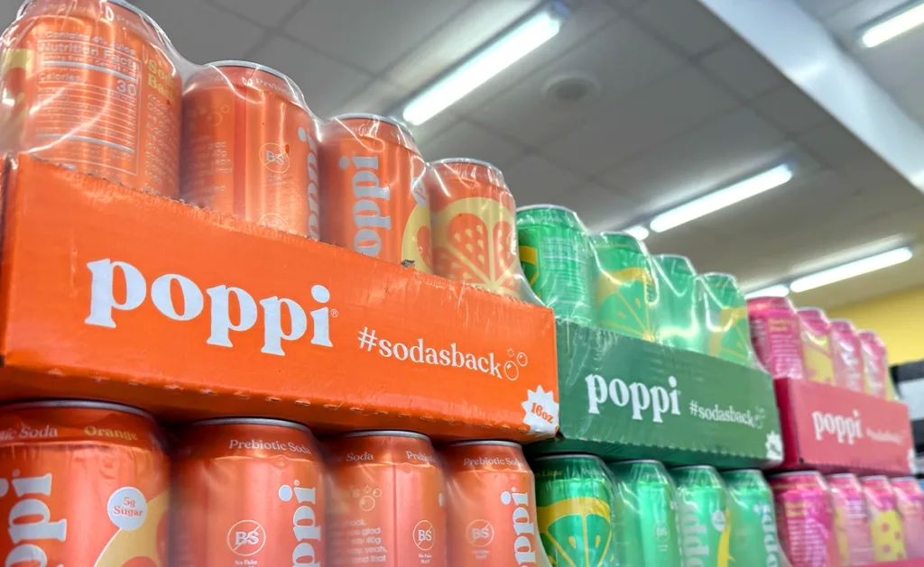 stacked cases of poppi prebiotic soda.