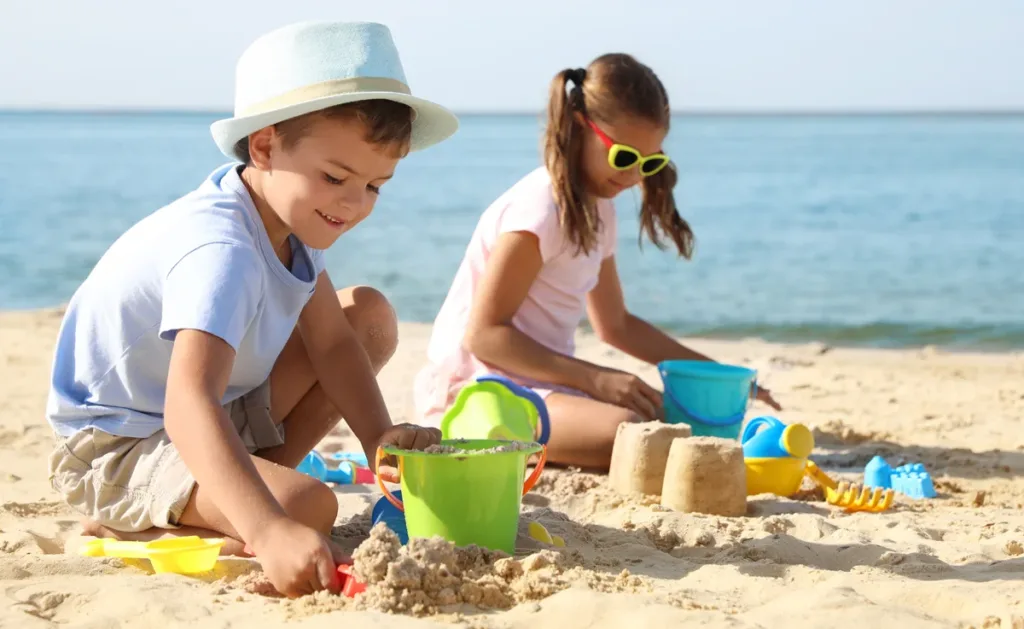 SF_BacktotheBeach_1200x675 Little children building sand castles at the beach