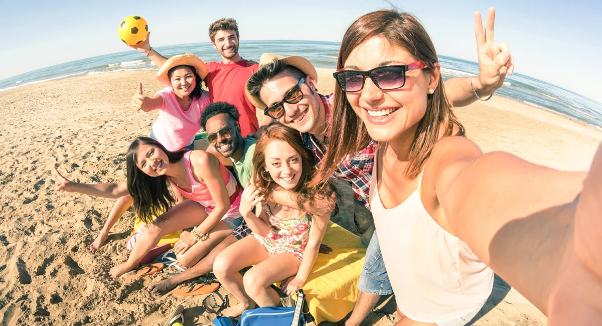 Multiracial group of friends having fun at the beach.