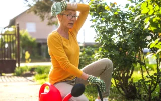 A person doing gardening work with an exasperated expression.