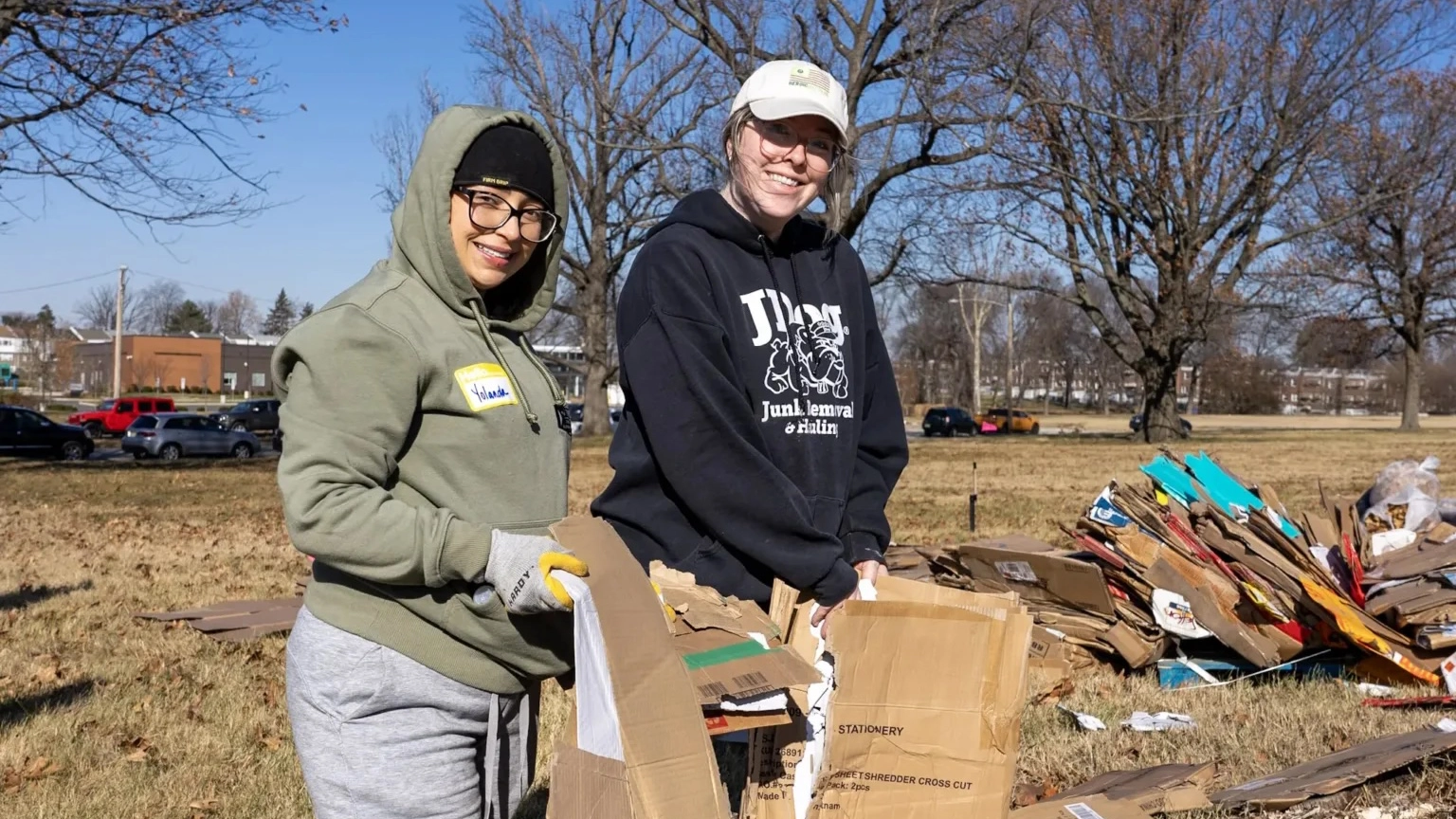 Volunteers at the Heroic Gardens project laying down cardboard