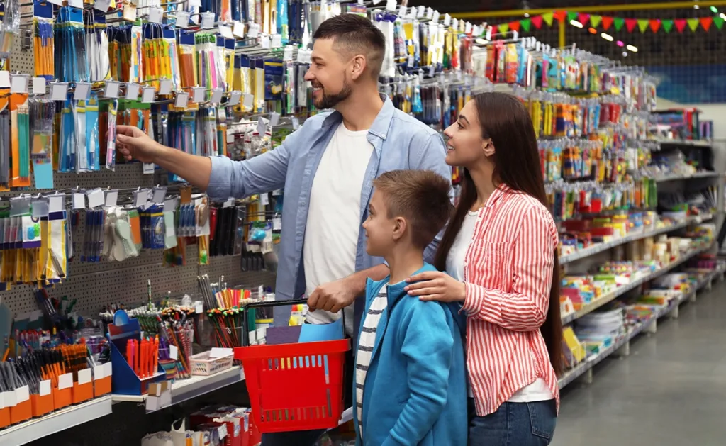 Parents shopping with children for school supplies.
