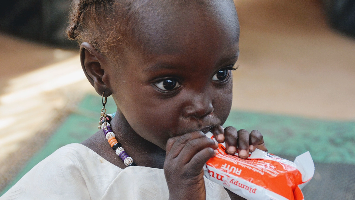 A child eating Plumpy'Nut.