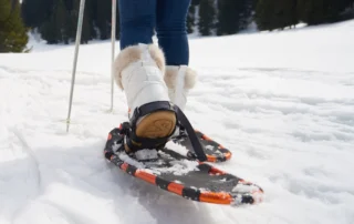 A person using snow shoes in a snowy landscape.
