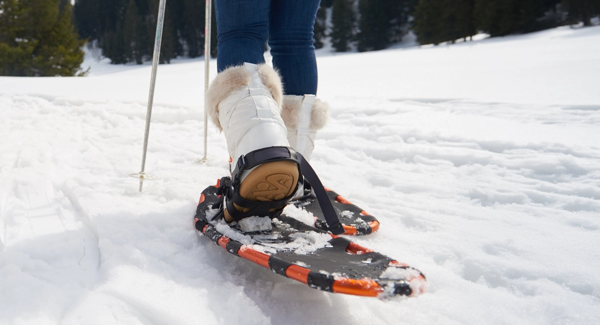 A person using snow shoes in a snowy landscape.