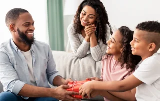 Family gives dad a gift for Father's Day.