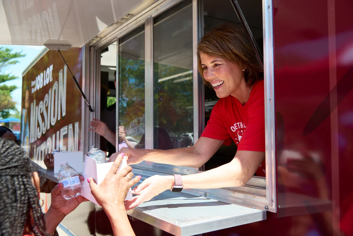 Helena Foulkes, a 2026 Rhode Island gubernatorial candidate, serving meals to kids from the Ocean State Job Lot Charitable Foundation’s Mission Kitchen at the John H. Rollins Recreation Center event in Providence, RI.