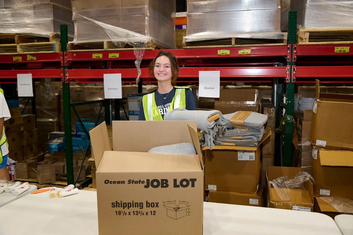 A volunteer packs Operation Sleep Well Kits.