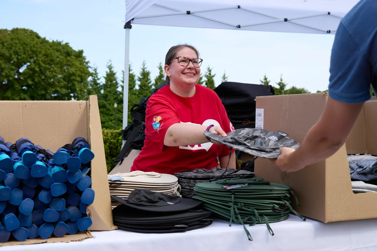 Ocean State Job Lot associate Christina Lantz giving various items to golfers before the 22nd annual Ocean State Job Lot Golf Tournament.
