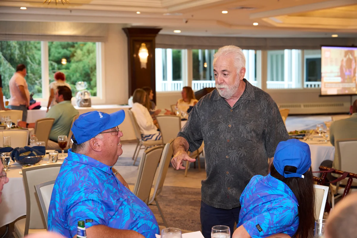 Ocean State Job Lot Owner Alan Perlman talking to a sponsor at the 22nd annual Ocean State Job Lot Golf Tournament.