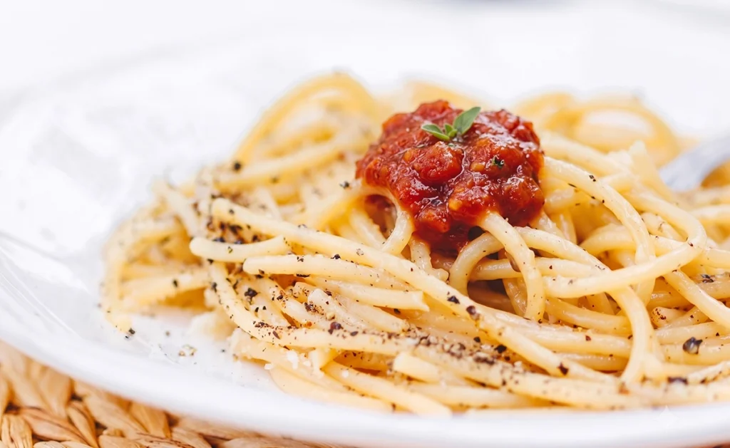 A pasta dish of spaghetti with red sauce.